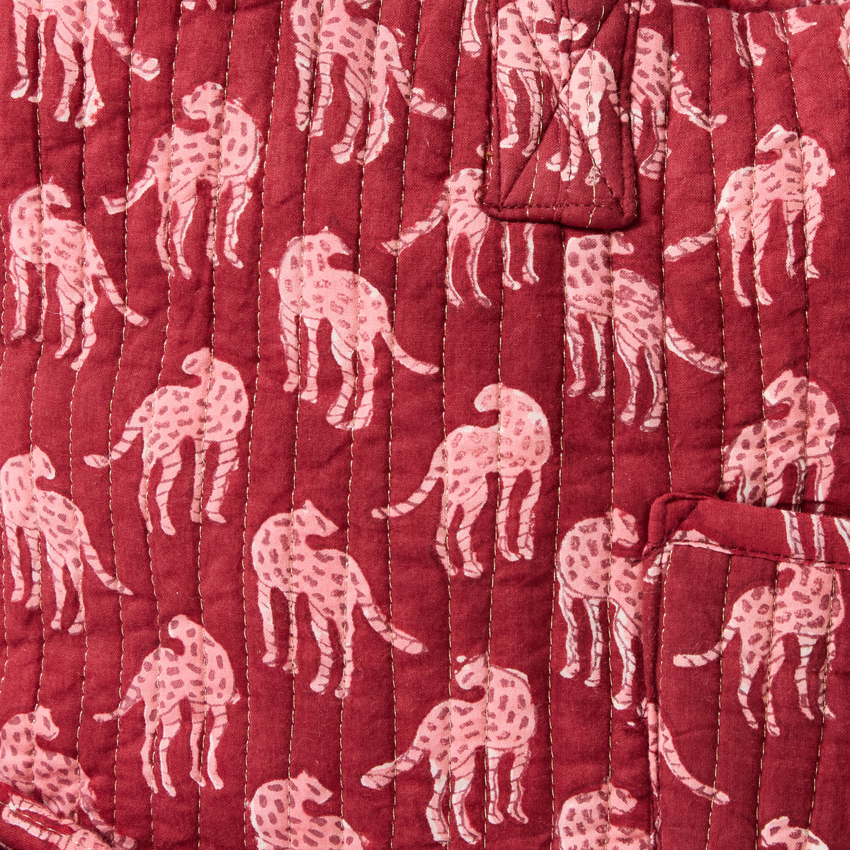 Quilted overnight duffel bag with burgundy background and pink cheetah pattern by Picnic Folk.
