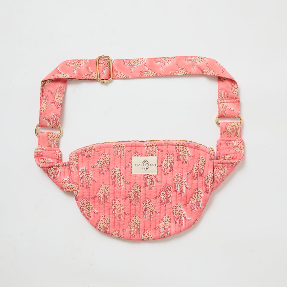 Handcrafted cross body bag in Cheetah Pink, quilted hand-block printed cotton by Picnic Folk. Gold hardware and adjustable strap.