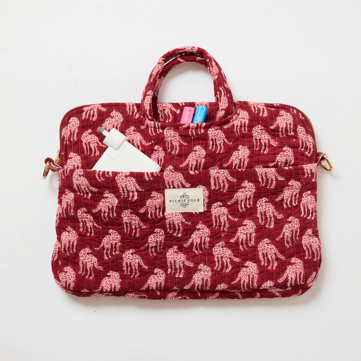 Handcrafted quilted laptop tote in Cheetah Plum by Picnic Folk. Removable shoulder strap and four pockets.