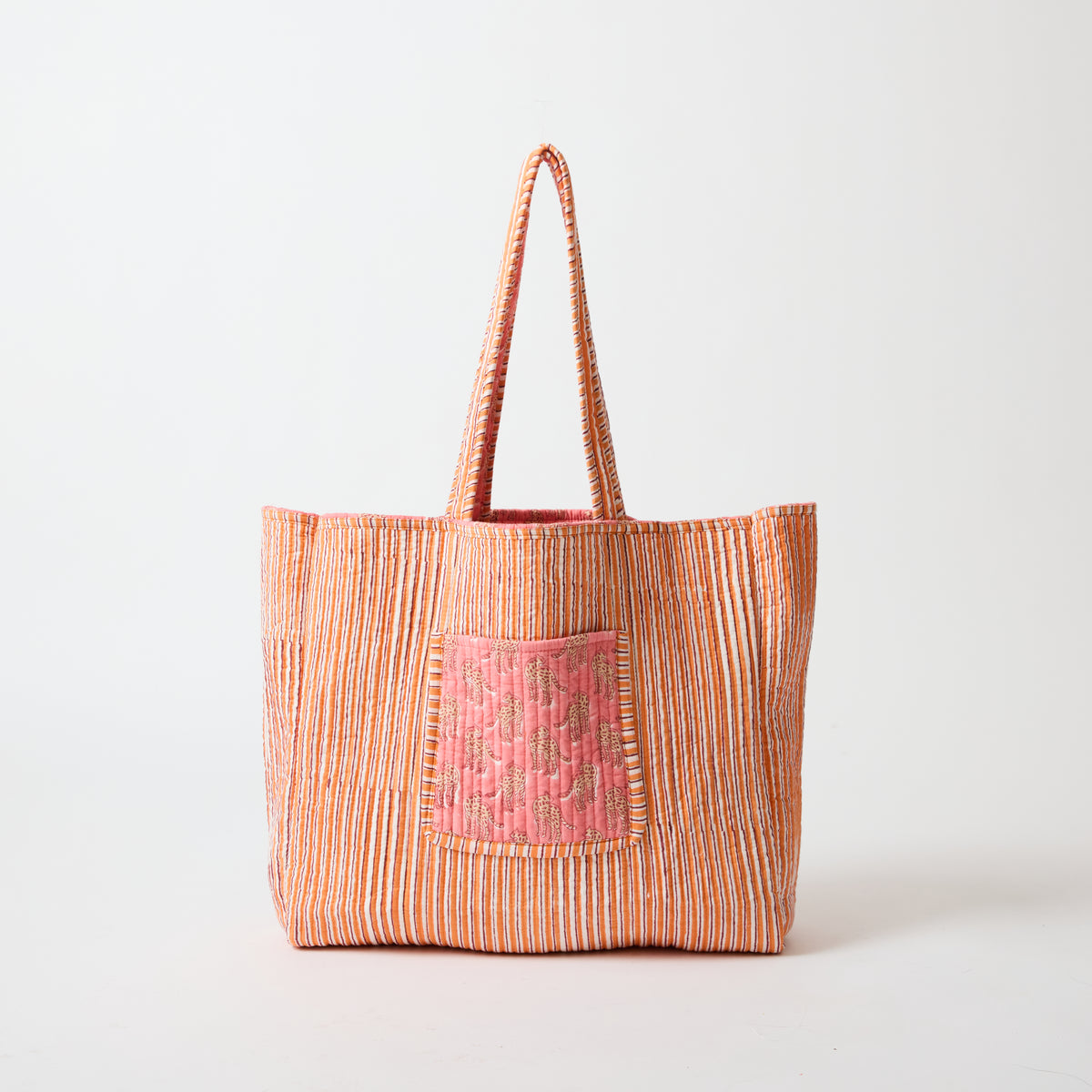 Reversible quilted tote bag shown in its orange stripe reverse side by Picnic Folk.