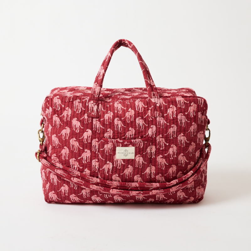 Handcrafted quilted overnight duffel bag in Cheetah Plum by Picnic Folk. Gold hardware and metallic quilting.