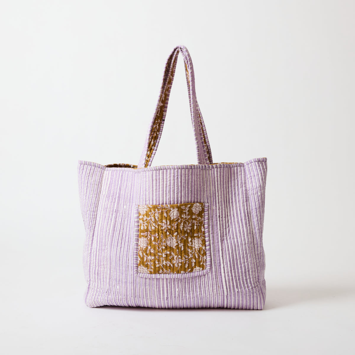 Reversible quilted tote bag shown in its purple stripe reverse side by Picnic Folk.